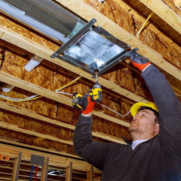 Male technician mounted air conditioner on ceiling ventilation system