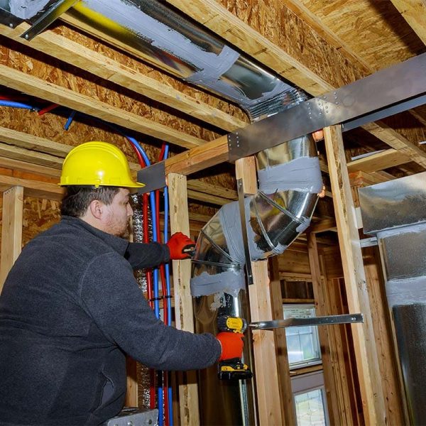 Workers making final air duct conditioning HVAC system stands for heating